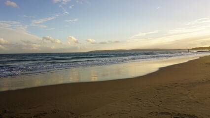 Composition of coastal sunset, featuring vivid indigo, blue, and purple colors. 