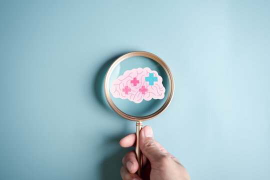 Magnifier focus to human brain icon and plus sign positive thinking concept, idea creative intelligence thinking or Awareness of Alzheimer, Parkinson's disease, dementia, stroke, mental health care.