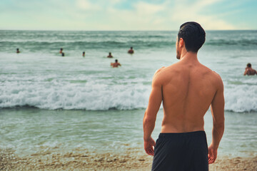 Handsome young man standing on a beach in Phuket Island, Thailand