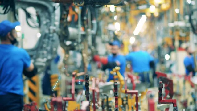 Fast motion of a mechanic using car factory equipment for spot welding