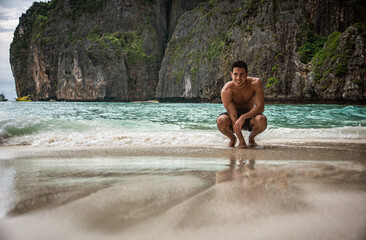 Handsome young man standing on a beach in Phuket Island, Thailand