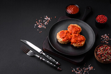 Delicious fresh cutlets or meatballs with spices, herbs and tomato sauce