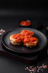 Delicious fresh cutlets or meatballs with spices, herbs and tomato sauce