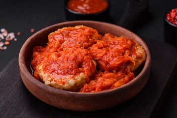 Delicious fresh cutlets or meatballs with spices, herbs and tomato sauce