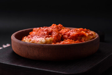 Fototapeta na wymiar Delicious fresh cutlets or meatballs with spices, herbs and tomato sauce