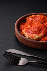 Delicious fresh cutlets or meatballs with spices, herbs and tomato sauce
