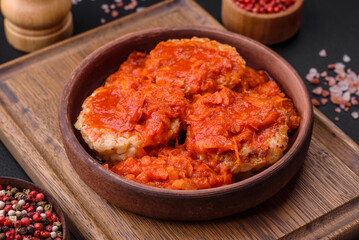 Delicious fresh cutlets or meatballs with spices, herbs and tomato sauce