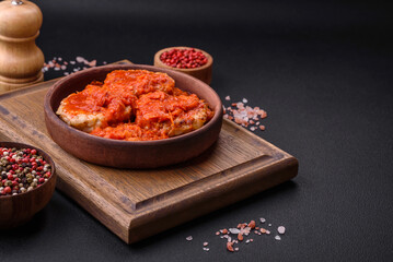 Delicious fresh cutlets or meatballs with spices, herbs and tomato sauce
