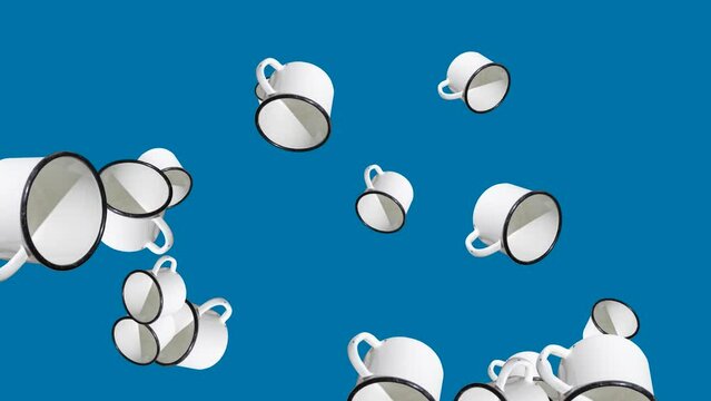 White enamel mug in abstract explosion flying in different directions on a blue background. Creative travel animation concept with mugs