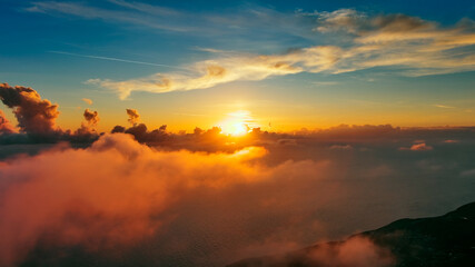 Fototapeta na wymiar Flying in bright sunset clouds