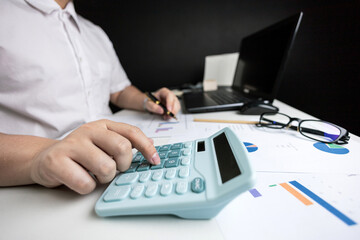 Male hand doing accounting, calculating bills, and expenses at home. Family budget bill payment checklist concept, pay bill check, income allocation plan, or Family budget hedge plan.