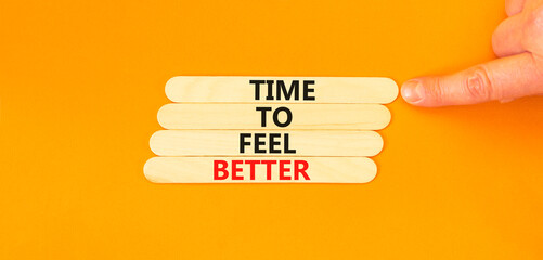 Time to feel better symbol. Concept words Time to feel better on wooden stick. Beautiful orange table orange background. Businessman hand. Motivational business time to feel better concept. Copy space