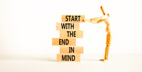 Start in end of mind symbol. Concept words Start with the end in mind on wooden blocks. Beautiful white table white background. Businessman icon. Business start in end of mind concept. Copy space.
