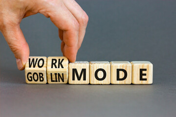 Work or goblin mode symbol. Concept word Work mode Goblin mode on wooden cubes. Businessman hand. Beautiful grey table grey background. Business work or goblin mode concept. Copy space.