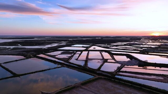Landscape at sunset. Aerial view from a drone of the landscape of marshes and salt flats of the Ria Formosa Natural Park. Atlantic Ocean. Algarve. Portugal. Europe