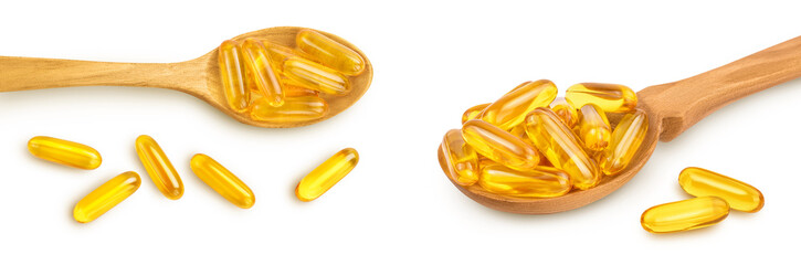 Fish oil capsules in wooden spoon isolated on white background with  full depth of field. Top view....