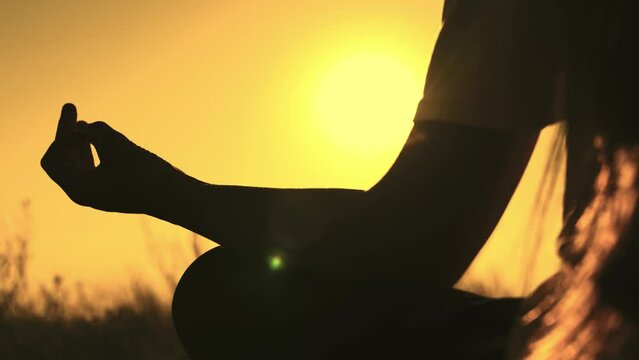 Yoga hand sunset closeup girl sitting pose silhouette woman sun. exercise stretching sport park nature health breathe sky love. party twilight astrology sunshine gesture meditating tourism social