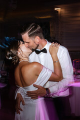 the first dance of the bride and groom inside a restaurant