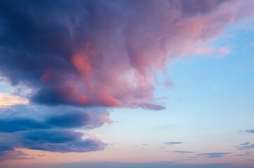 Naklejka na ściany i meble Overcast sky with pink clouds after sunset.