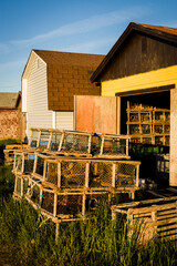 Wooden lobster traps in front of fisherman's sheds in North Lake, Prince Edward Island, Canada.