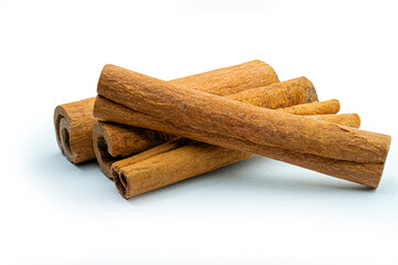 Cinnamon sticks close-up view, macro photography, isolated on white background high quality details