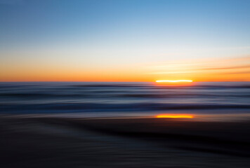 Fototapeta na wymiar Abstract beach sunset using intentional camera movement 