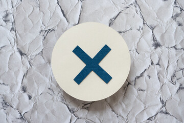 letter X or symbol on paper circle on scrapbook paper with crumpled paper texture