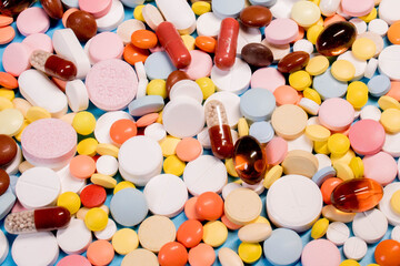Many colorful different medicines and pills on top. The concept of medical treatment