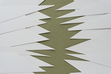 overlapping gray paper shapes (zig zag border)