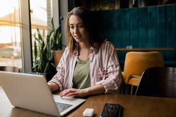 Woman working on laptop in café