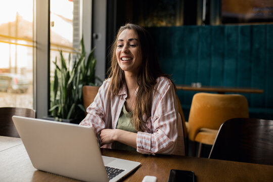 Beautiful woman using a laptop in a restaurant.
