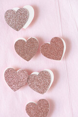 glitter and paper hearts with 3d effect on folded pink tissue paper