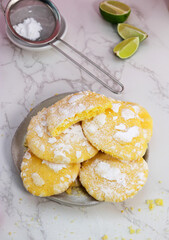upper view of delicious lemon cracked cookies with sugar powder on a plate
