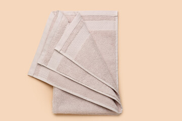 Folded soft towel on beige background