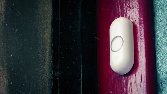 Person Rings Doorbell In Snowfall
