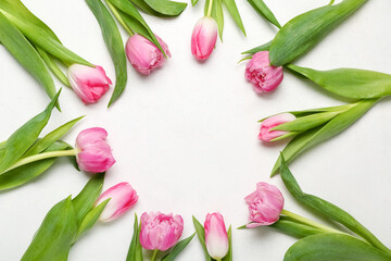 Frame made of beautiful tulip flowers on light background. Mother's Day celebration