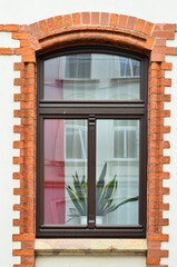 View of brick building with wooden window