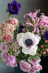 Beautiful bouquet of spring flowers in a vase on the table. Lovely bunch of flowers. Soft focus.
