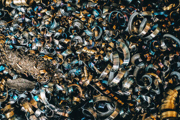 Steel scrap processing. Aluminum shavings after processing metal parts on a CNC lathe.
