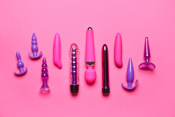 Vibrators with anal plugs on pink background