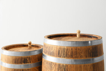 Wooden barrels on light background, closeup