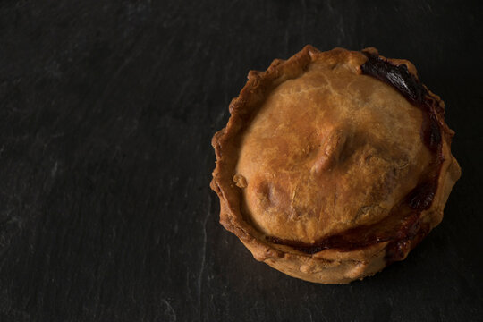 An empanada, a typical product of Mallorcan pastries, on a slate tile.