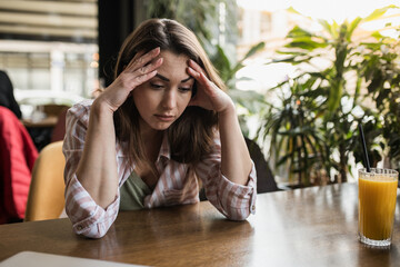 Young woman worried in a restaurant