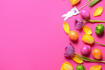 Composition with beautiful tulip flowers, painted Easter eggs and decor on color background