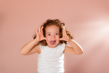 Cheerful red-haired girl making hand gesture to the camera.