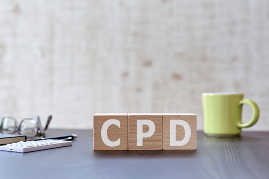 There is wood cube with the word CPD. It is an acronym for Continuing Professional Development an eye-catching image.