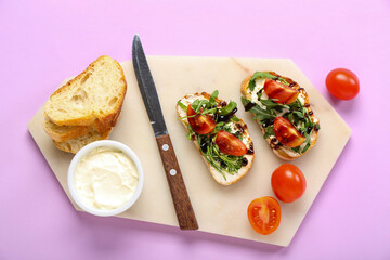 Board of tasty sandwiches with cream cheese, arugula and tomatoes on color background