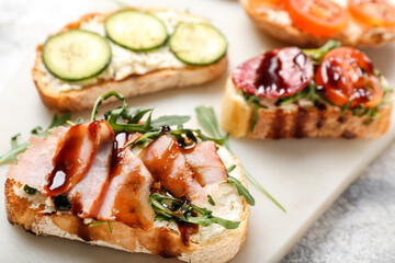Board with delicious sandwiches, closeup