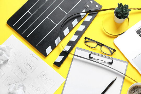 Clipboard with movie clapper, film reel and eyeglasses on yellow background