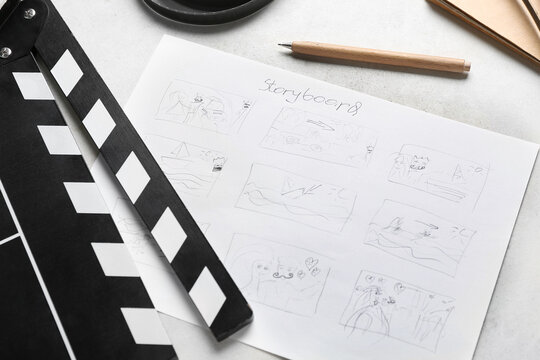 Movie clapper with storyboard on light background, closeup
